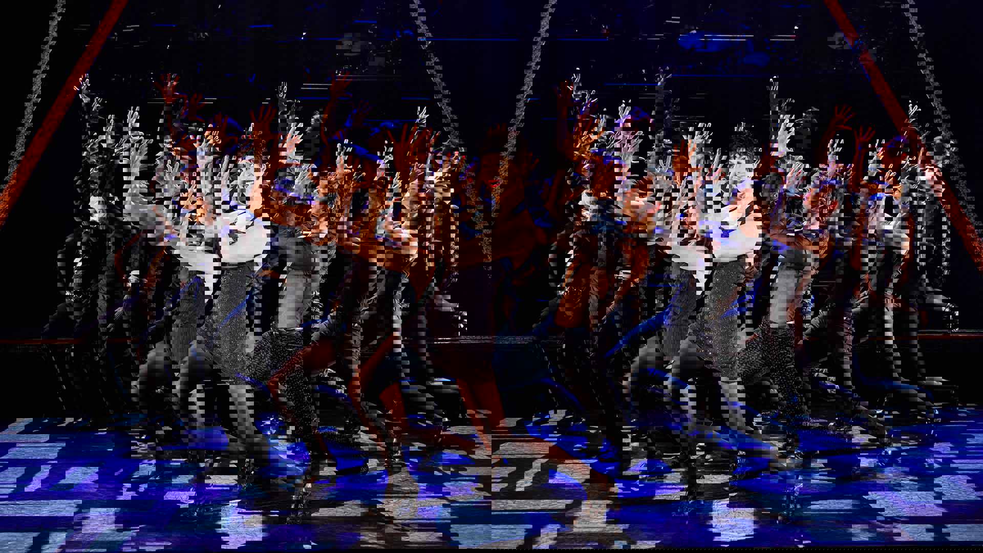 The cast of Chicago performing on stage.