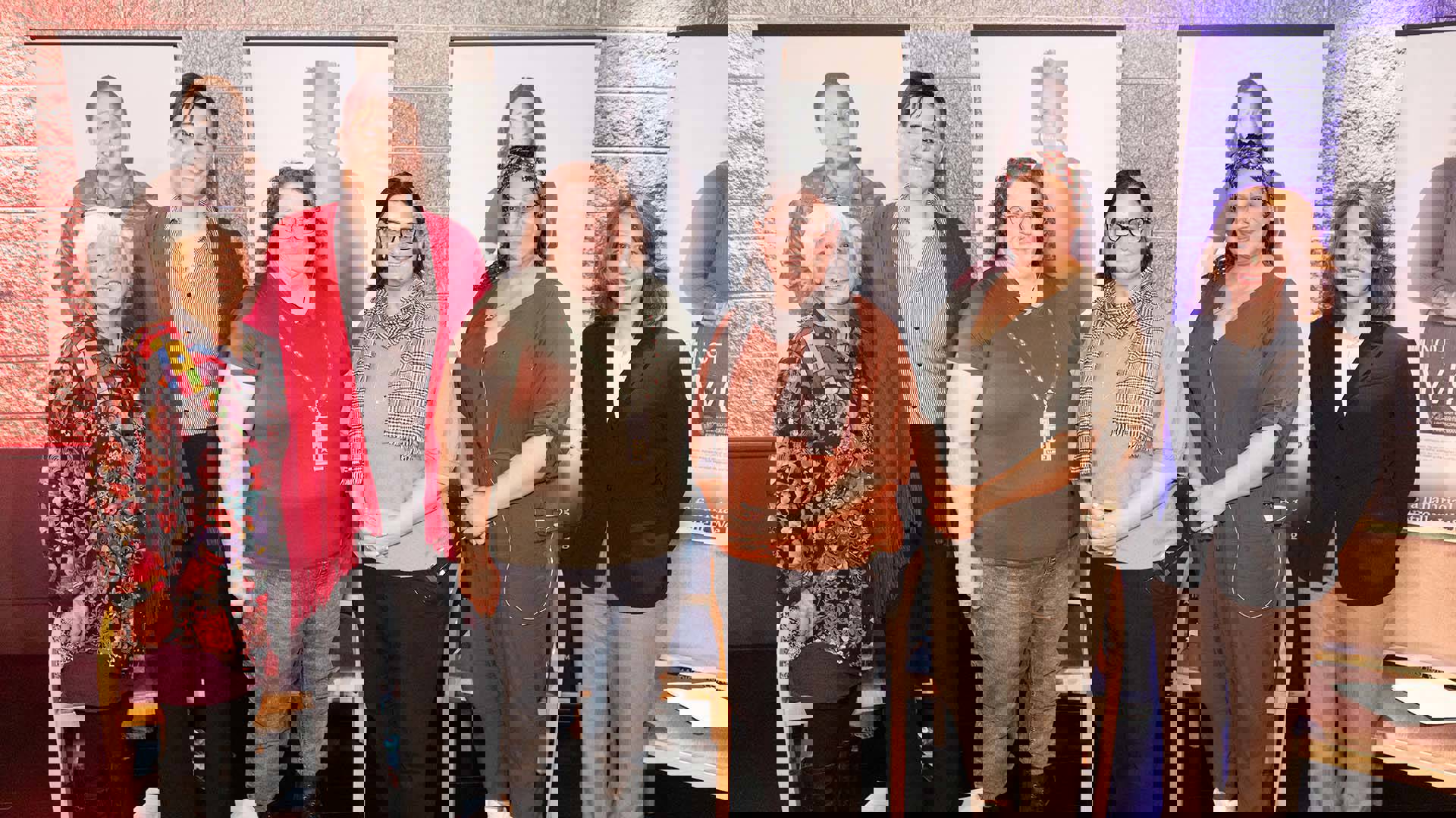 A group of 6 women stand together for a photo.