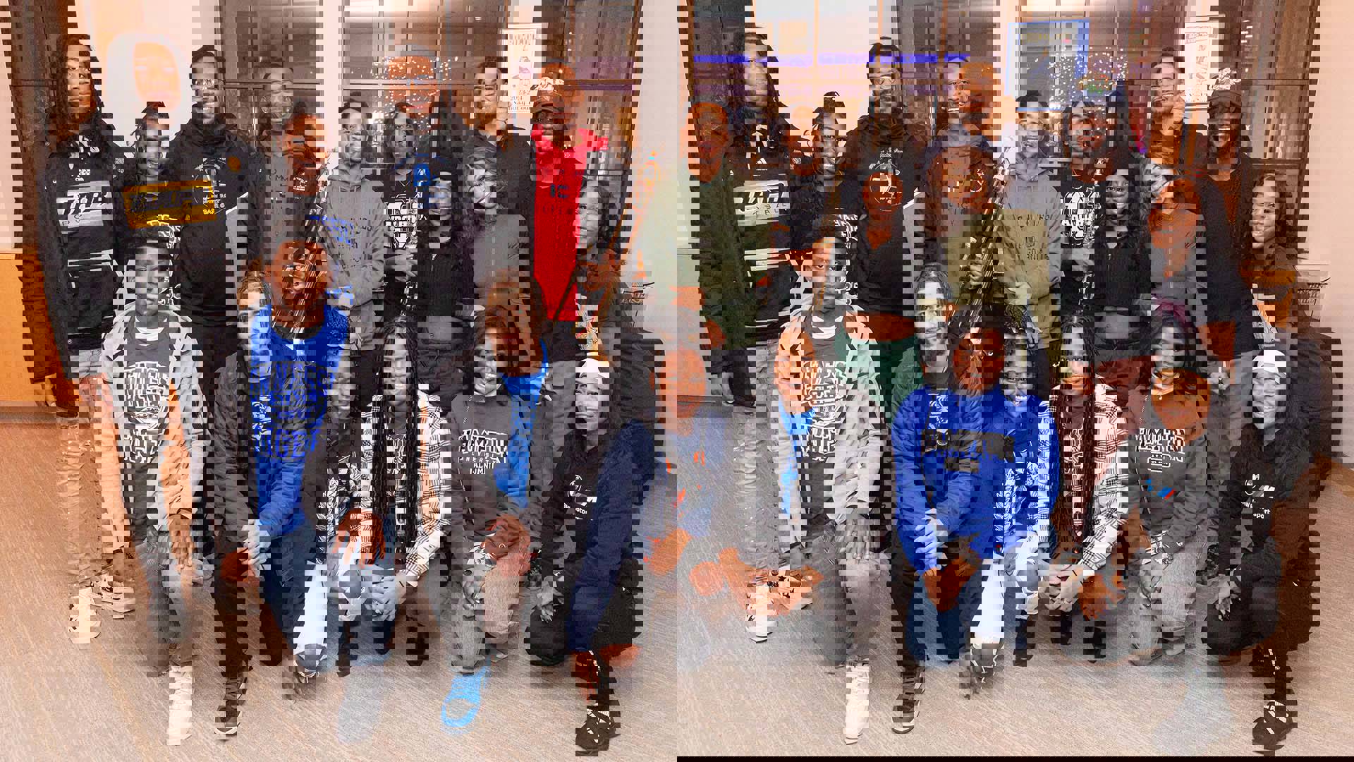 The cast of drumline live in street cloths posing for a photo together.