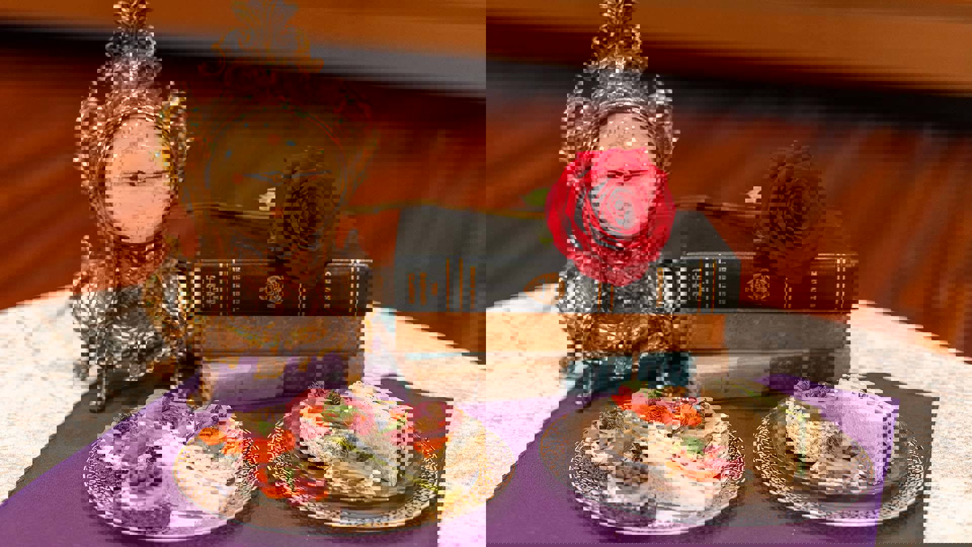 A small table holds two plates of small sandwiches, an old antique clock, and a stack of three books with a single red rose on top.