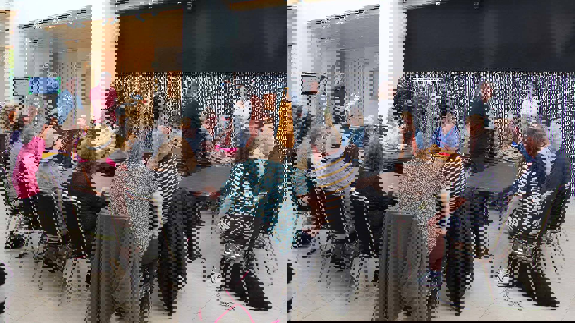 A group of people sitting in a circle in Overture Hall lobby.