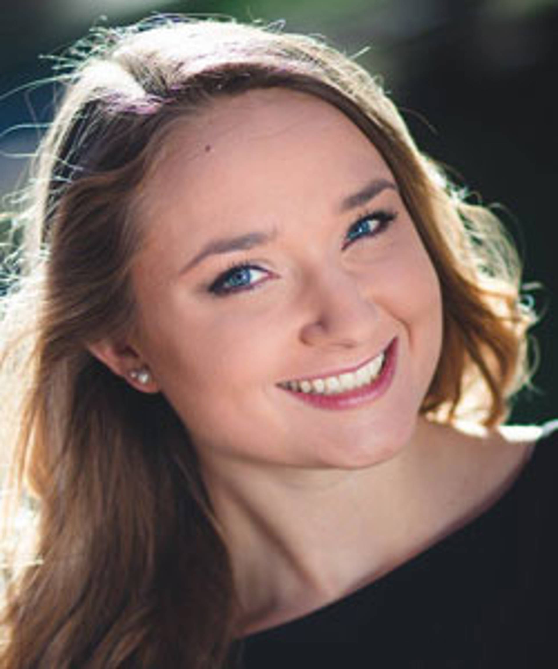Headshot of a caucasian woman with blue eyes and brown hair