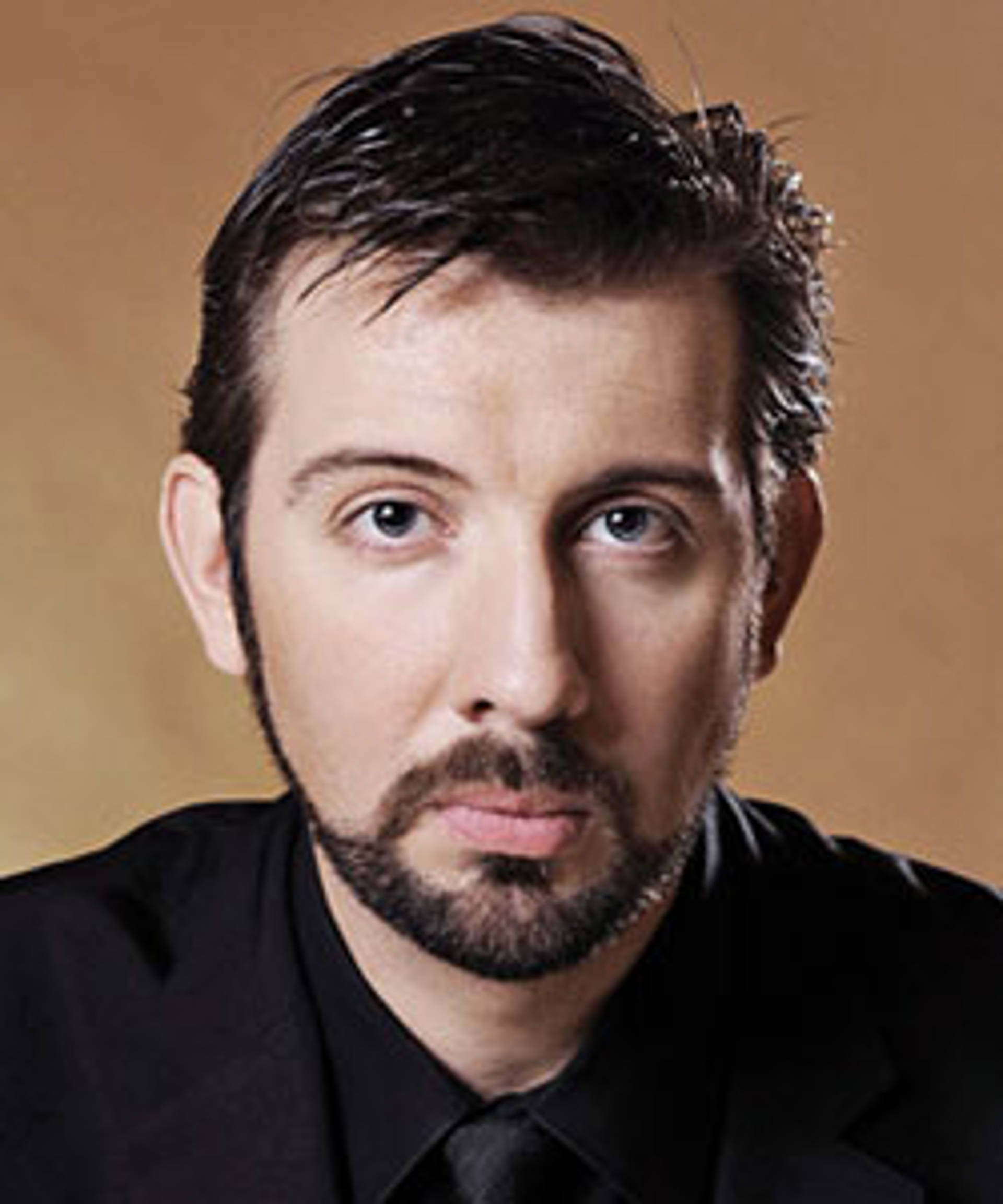 Headshot of a caucasian man with brown eyes and short brown hair