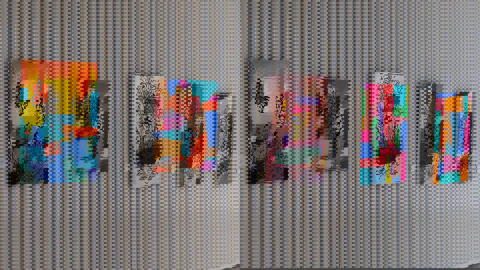 A gallery wall full of colorful paintings.