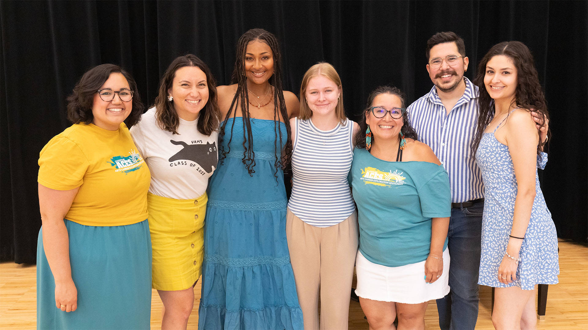 A group of people smiling together for a photo.