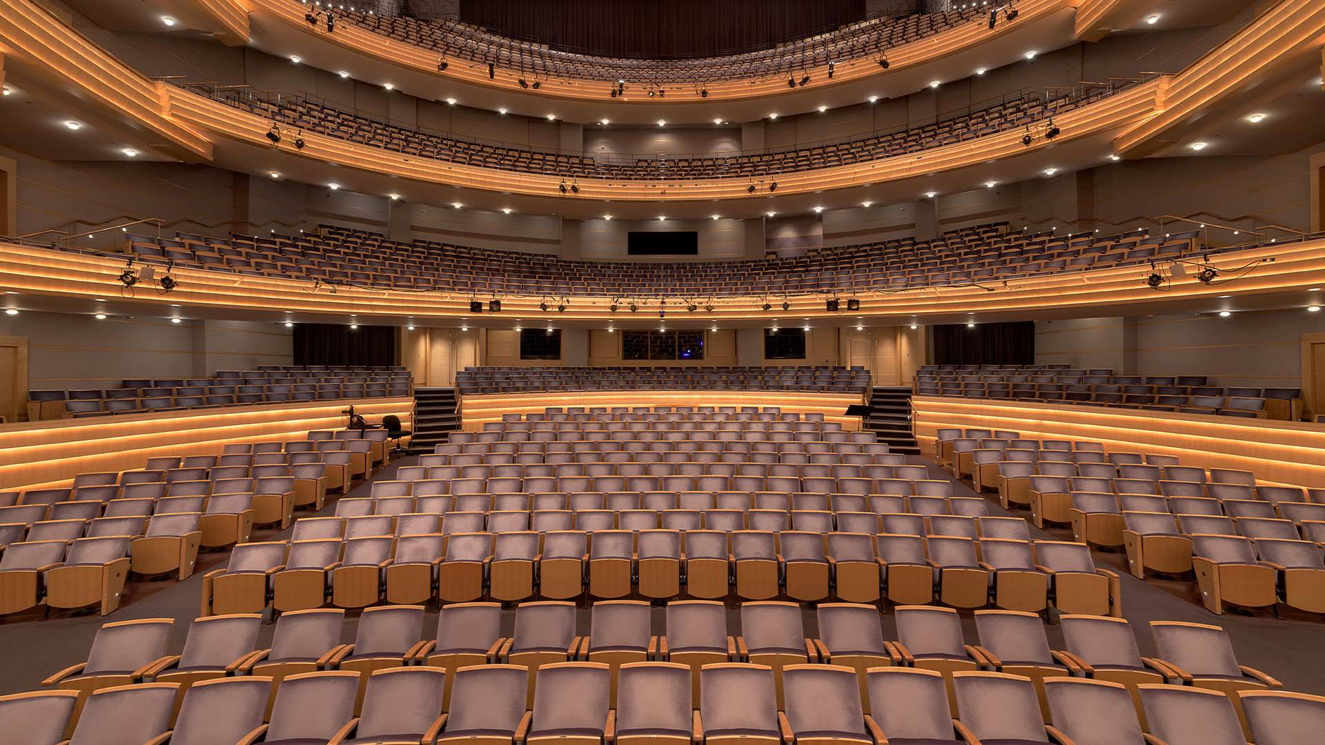 A view from Overture Hall stage looking out into four levels of empty seats. 