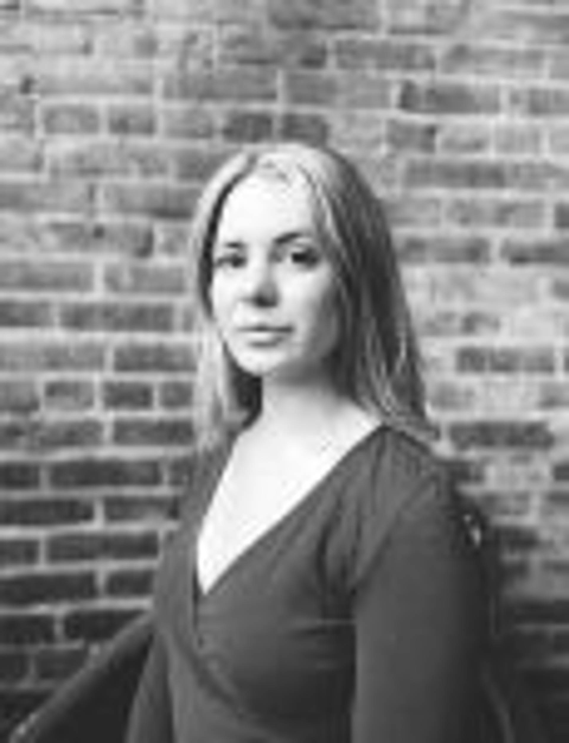 black and white headshot of a young woman with blond hair.