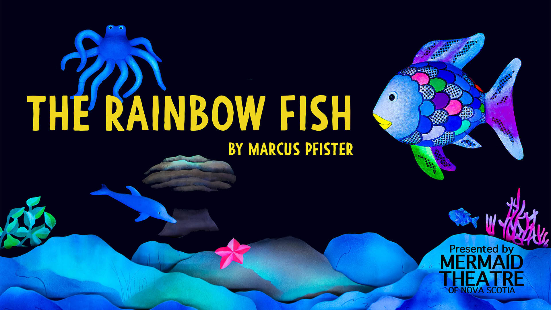 Banner reads: "The Rainbow Fish. By Marcus Pfister. Presented by Mermaid Theatre of Nova Scotia." Puppets of a blue octopus, porpoise, pink starfish and a fish with rainbow scales swimming. They are above blue bedrock and pink coral.