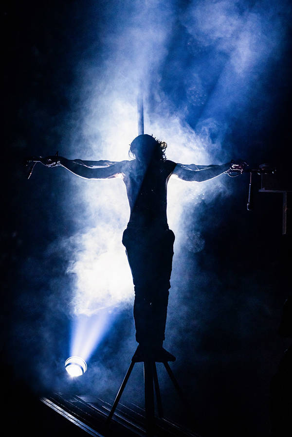 A prop of Jesus Christ on the cross. Backlit by a spotlight.