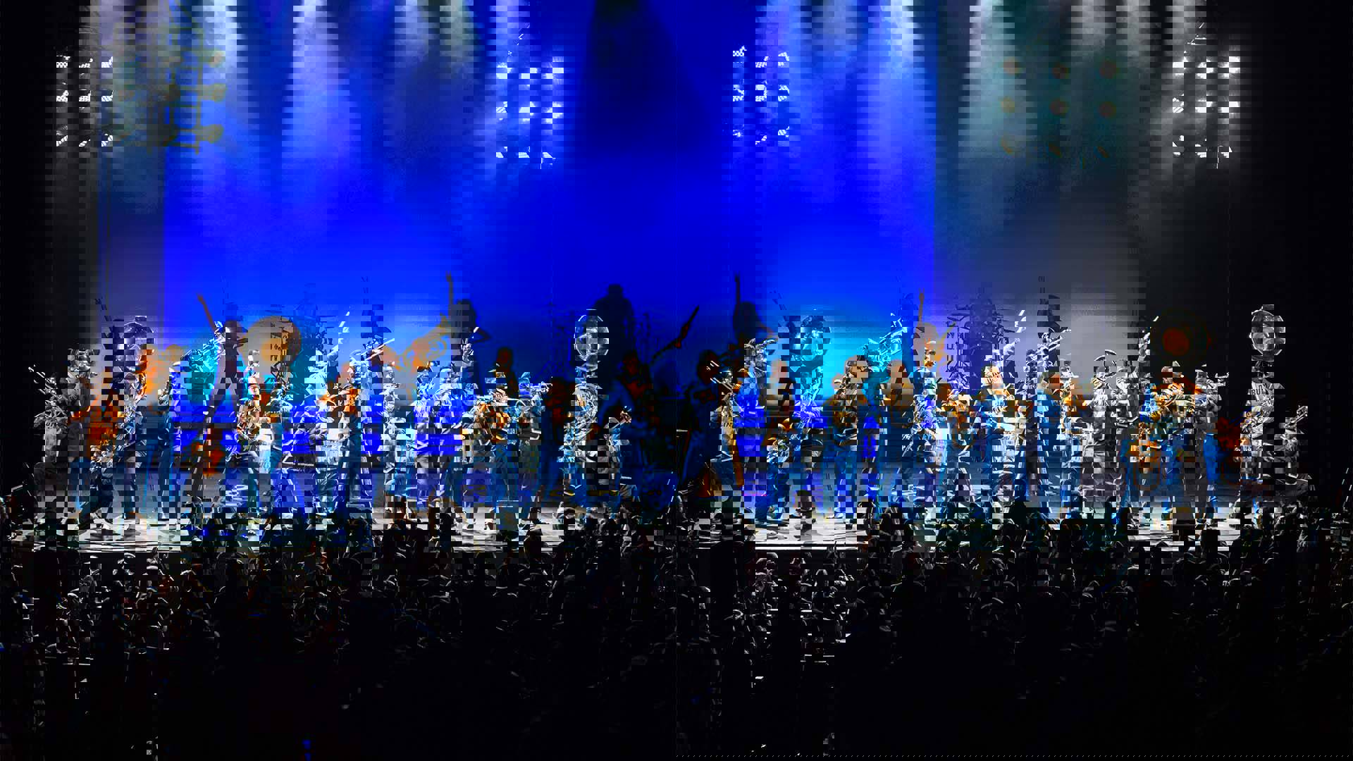 Drumline Live's African-American marching band performing on stage to a standing audience.