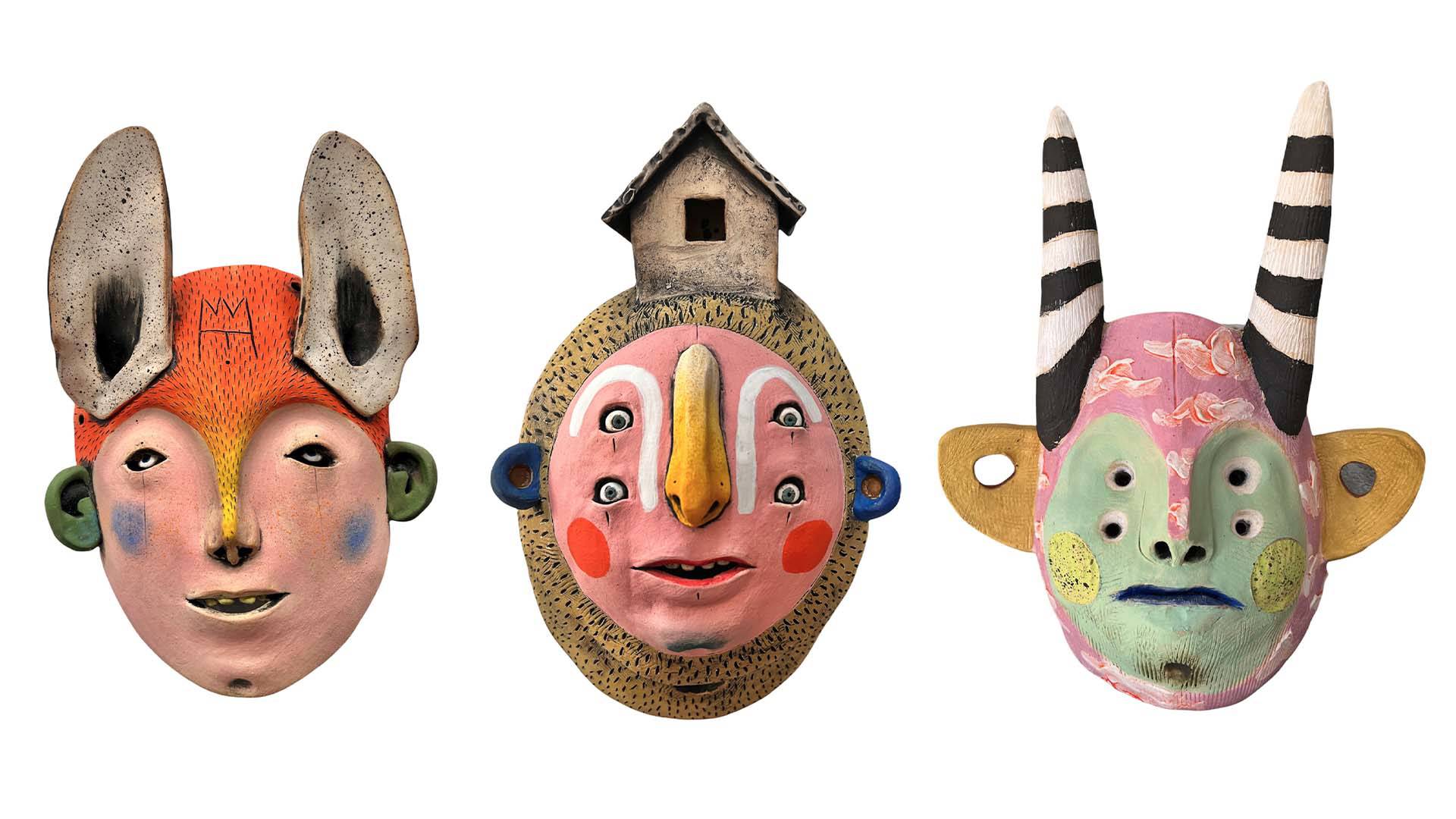 Three colorful masks that incorporate human and animal elements.