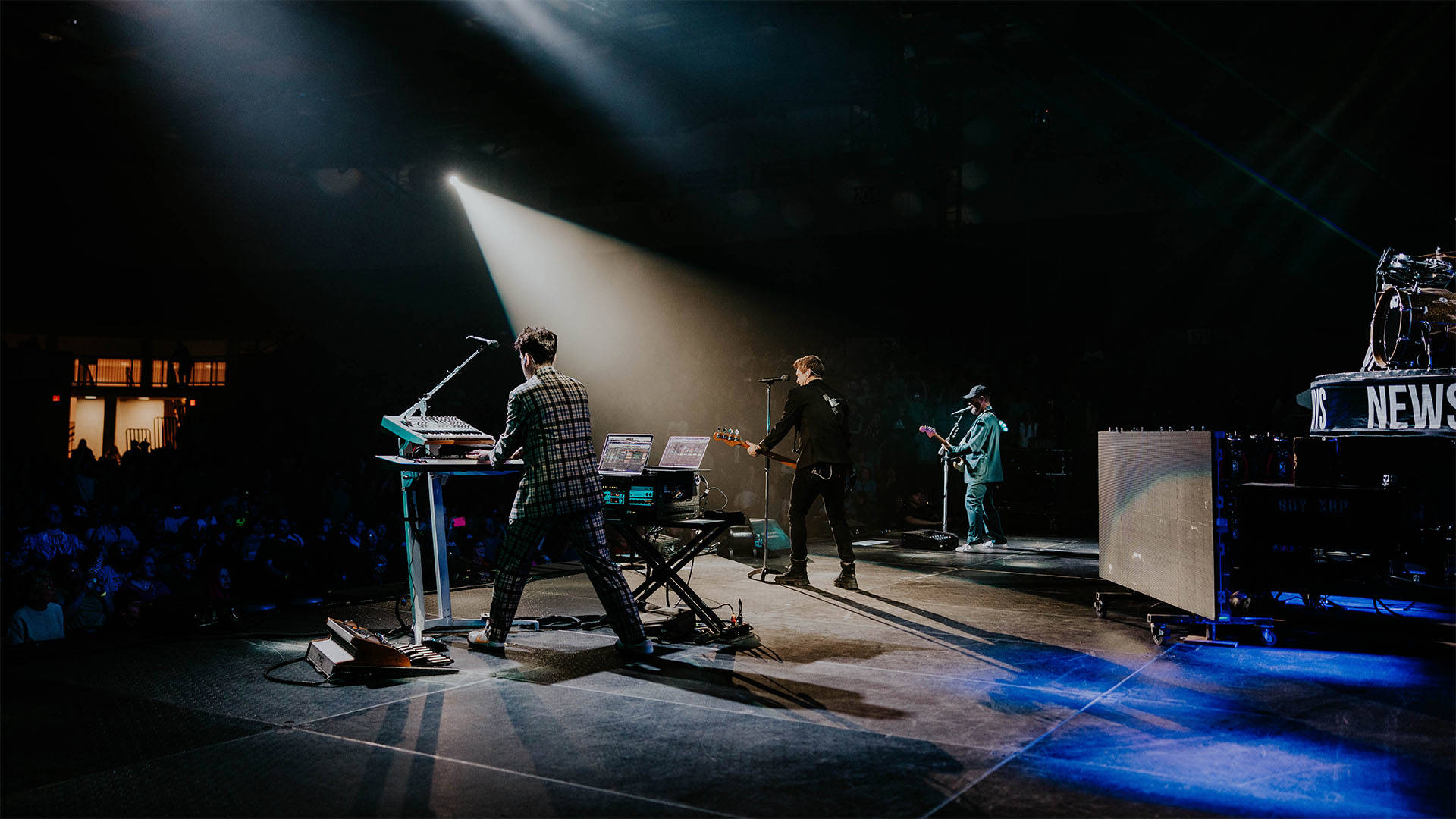 Shot of a band performing on a stage from behind.