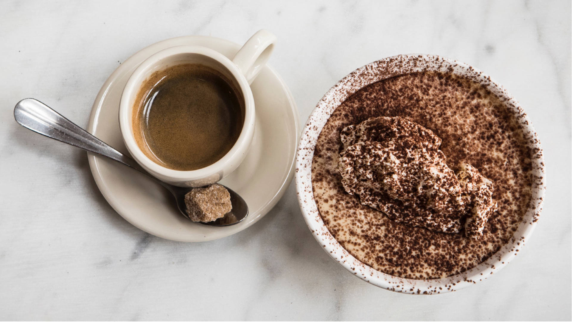 Top-down view of two espresso drinks.