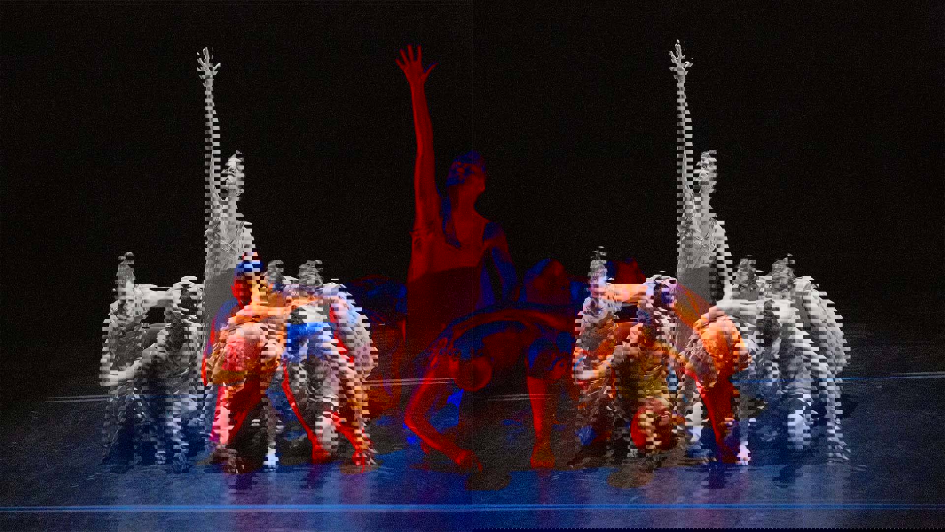 A group of dancers performing onstage. 