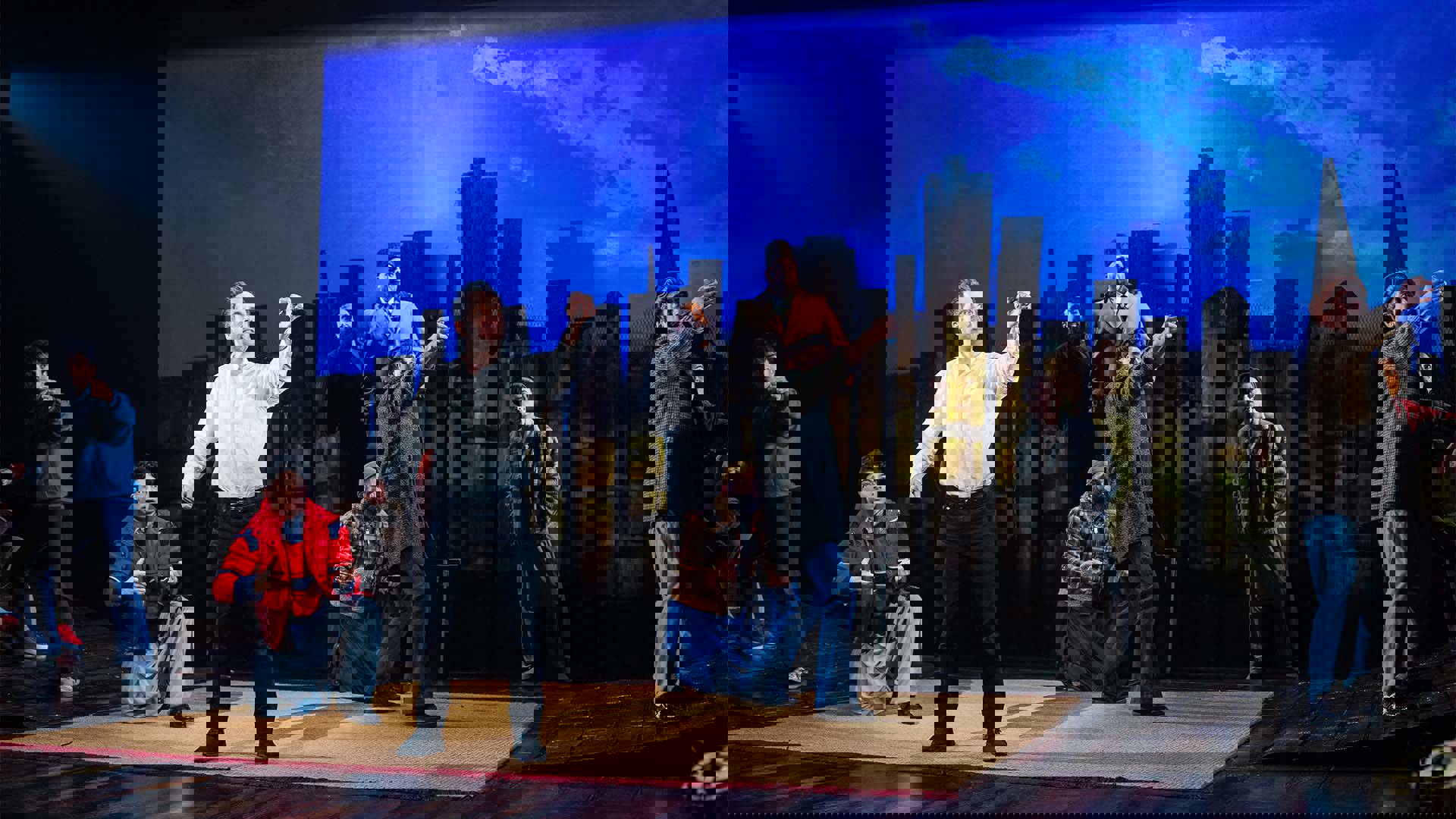 The cast of The Kite Runner in a variety of outfits. Most are reaching out as if guiding invisible kites.