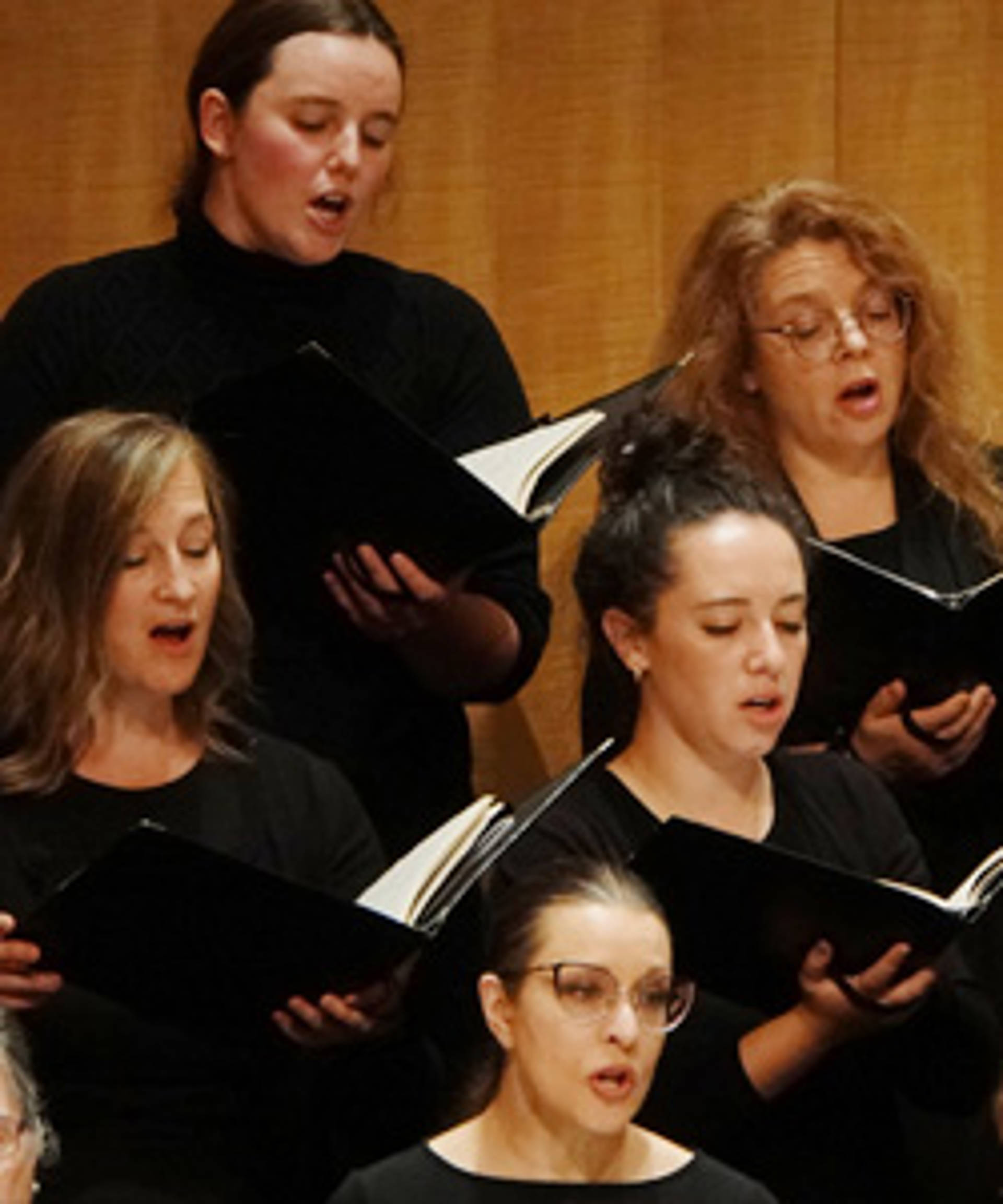 A choir of singers in black