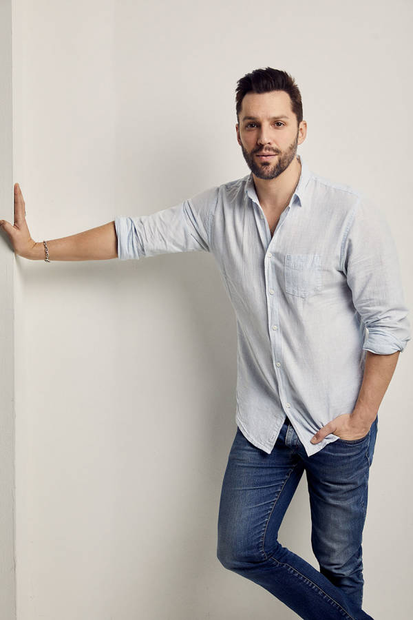 Headshot of Ryan Silverman. He has a handsome youthful face with short brown hair and brown eyes. He is wearing a light blue button up shirt.