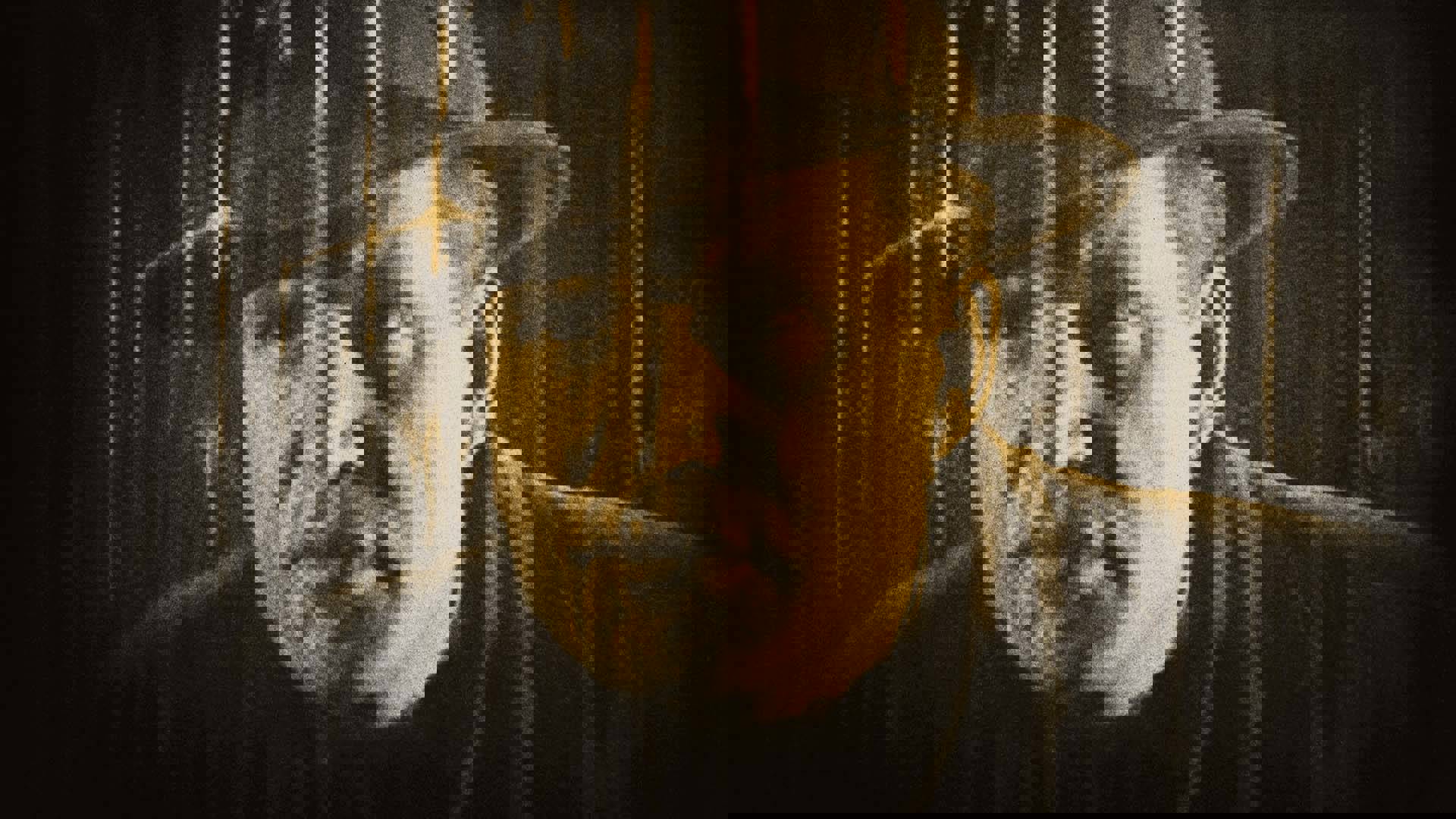 Dave Taylor (played by Rockliffe Fellowes), a man with a light complexion wearing a fedora hat, looks through a train car window in a scene from "The Signal Tower (1924)."