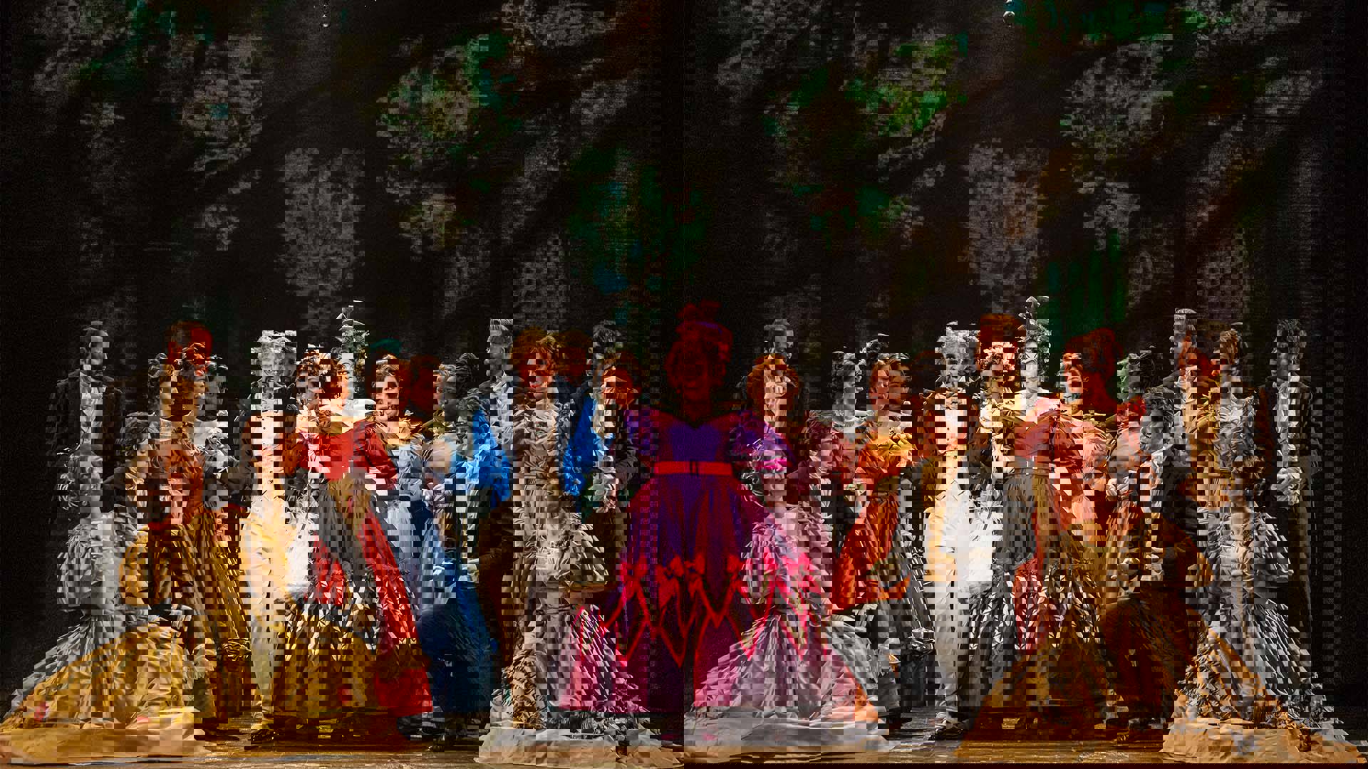 The cast of Les Miserables performing in high end French revolutionary era formal wear.