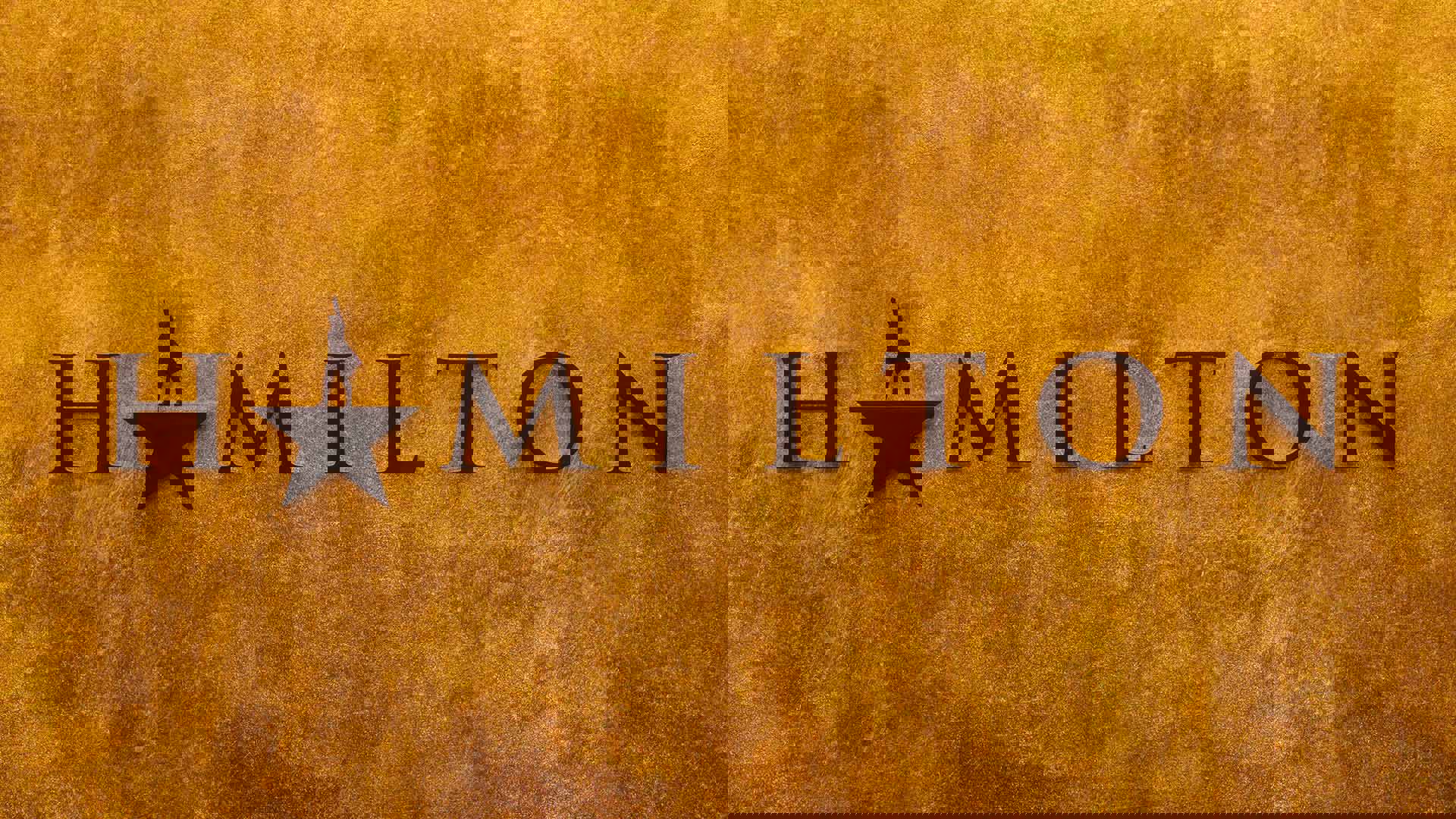 Rustic golden banner that reads "Hamilton" in black serif font. The "A" is a black star with the top point replaced with the silhouette of a man in a longcoat with one arm raised up.