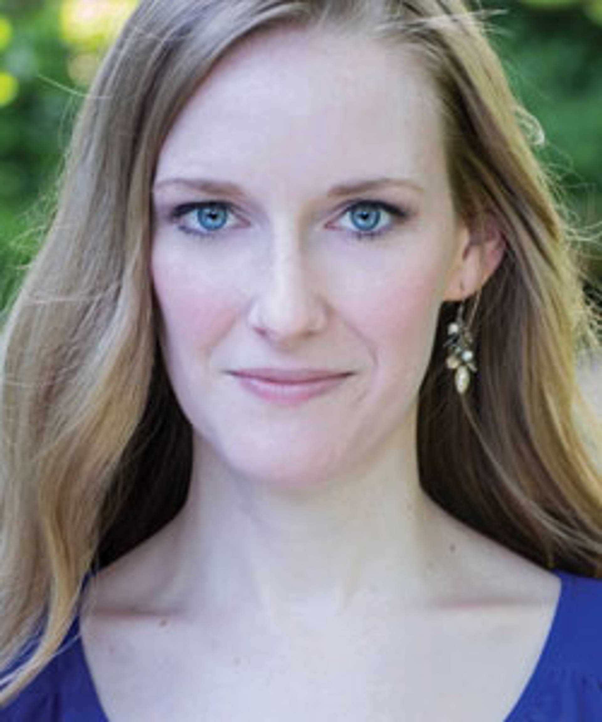 Headshot of a caucasian woman with blue eyes and short fine light brown hair