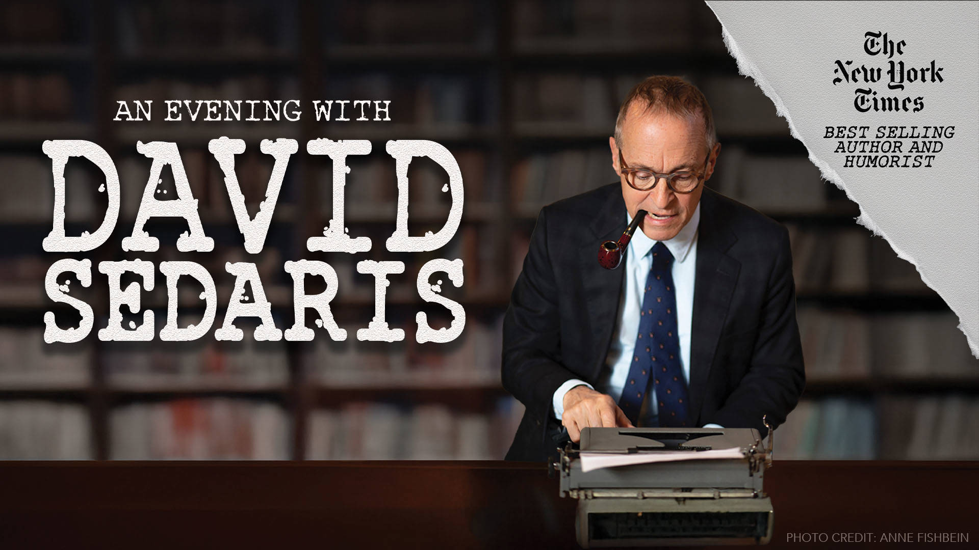 Banner reads: "An Evening with David Sedaris. The New York Times best selling author and humorist." A photo of David Sedaris, an older white man in a black suit, blue tie, with brown glasses and a wooden pipe in his mouth, leans over a typewriter with a wall of books behind him.