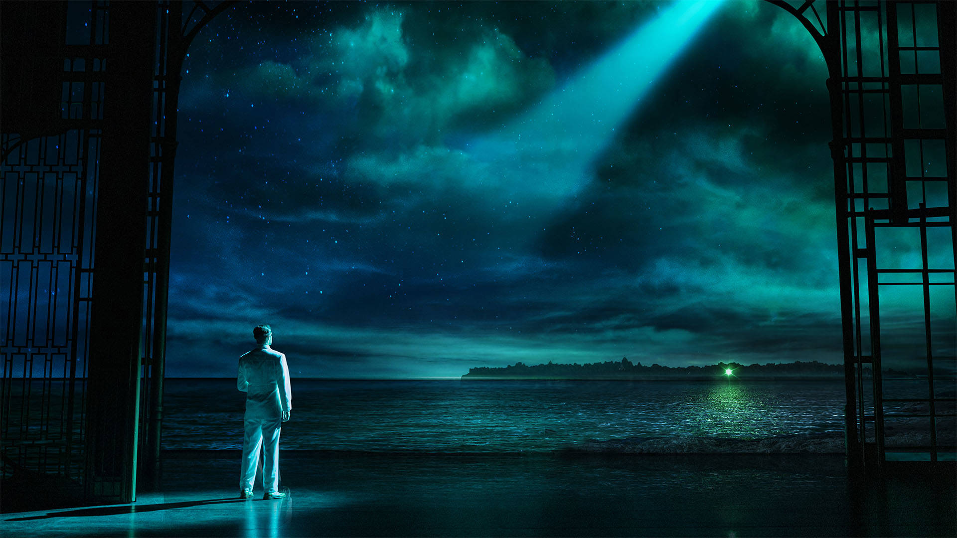 A man in a white suit stands with his back facing the camera, staring at a green light across a large body of water. A spotlight shines on him with a green-tinted night sky with clouds.