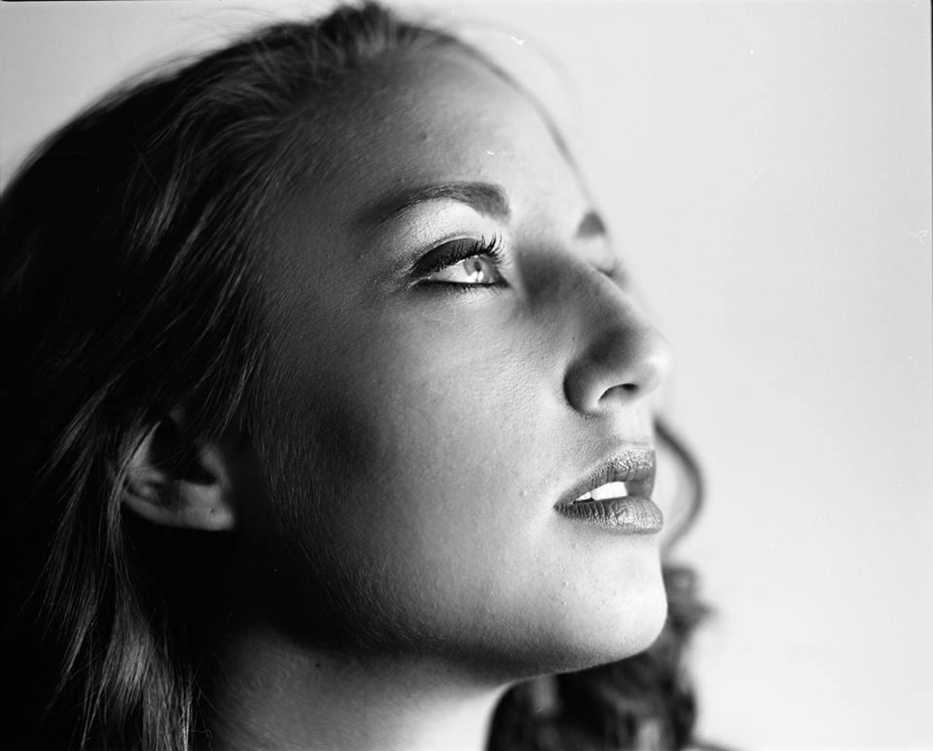 Greyscale headshot of a woman with light complexion & dark hair