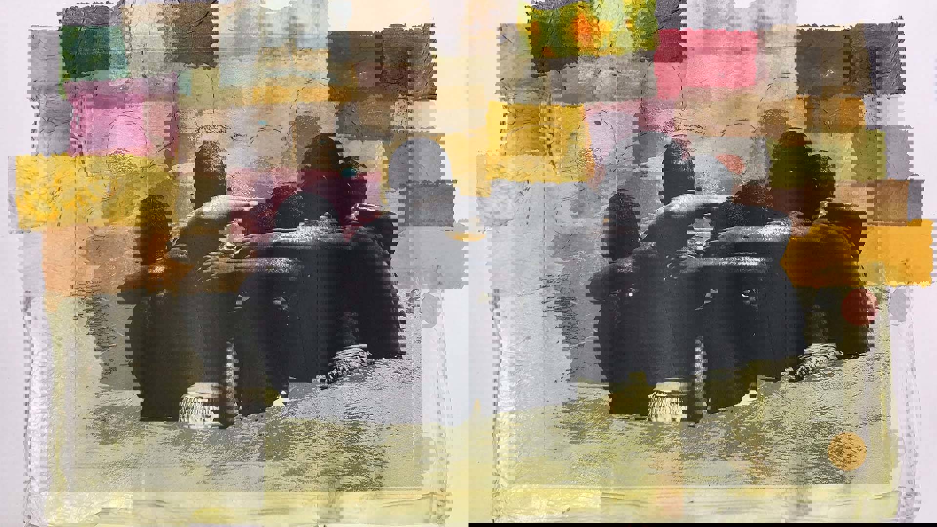 artwork featuring a greyscale photos of young boys with dark complection empbracing eachother against a colorful background.