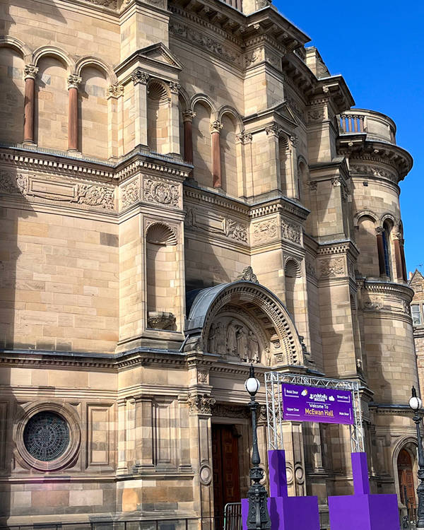 An ornate brick facade of a large building.