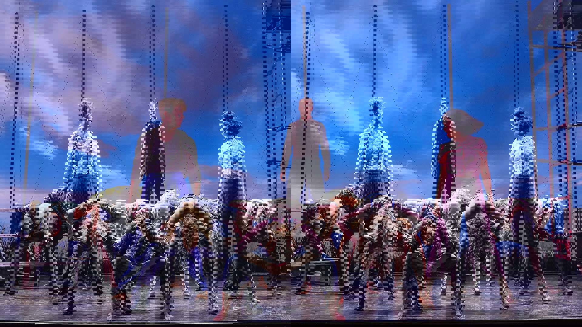 Three cast members of Water for Elephants stare at each other in a triangle formation.