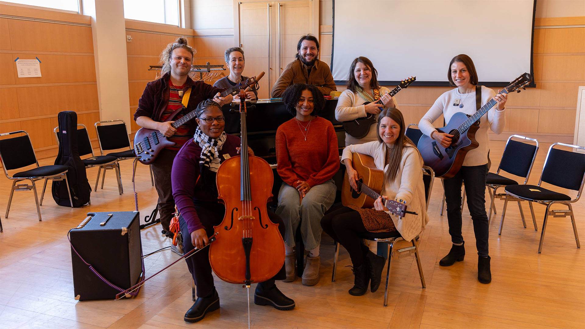 A group of musicians posing together for a picture with their instruments.