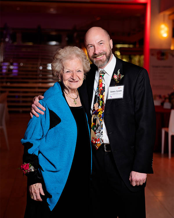 A middle-aged man and an older woman pose for a photo.