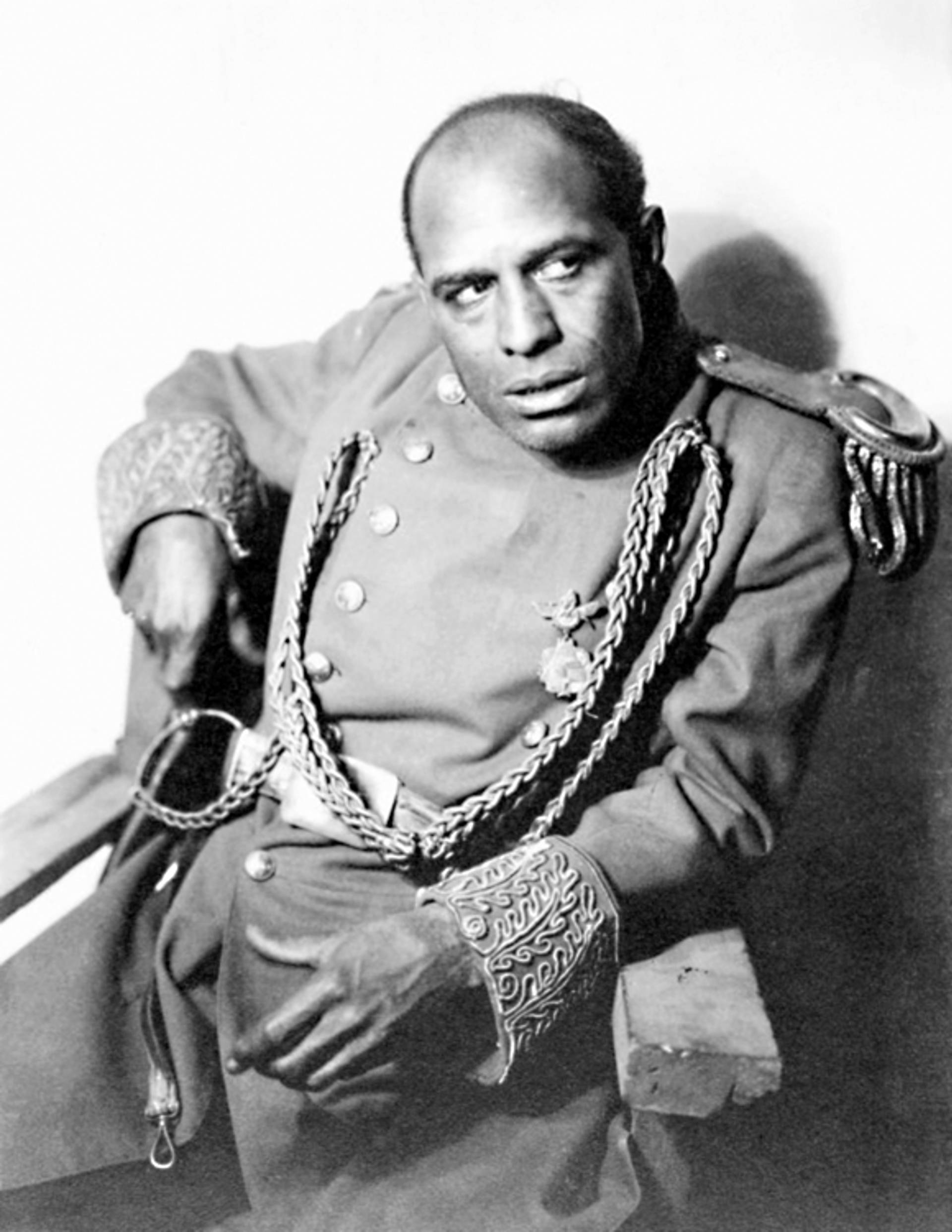 A still from an old silent film of an African American man in a military outfit.