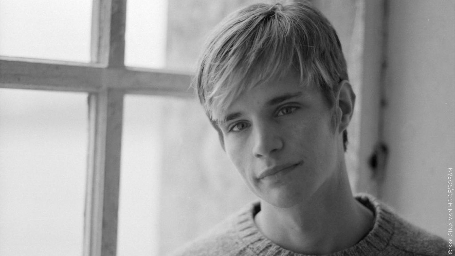 Matthew Shepard in black and white, a young caucasian man with blond short hair wearing a wool sweater.