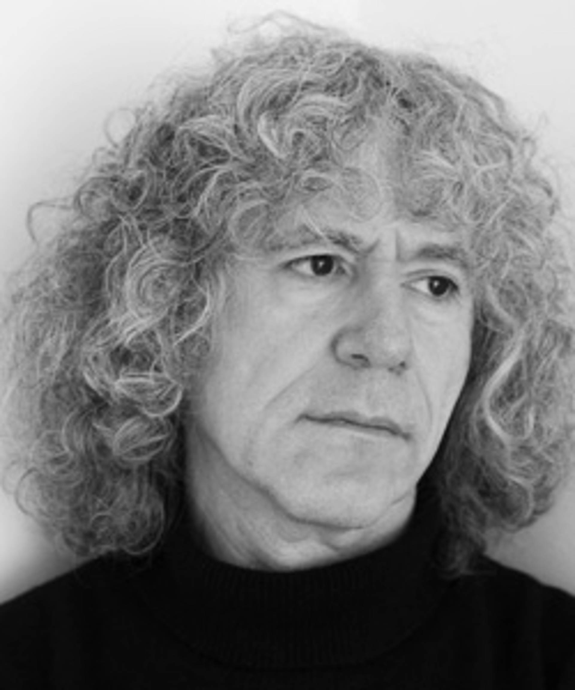 Grayscale headshot of a white man with long curly grey hair.