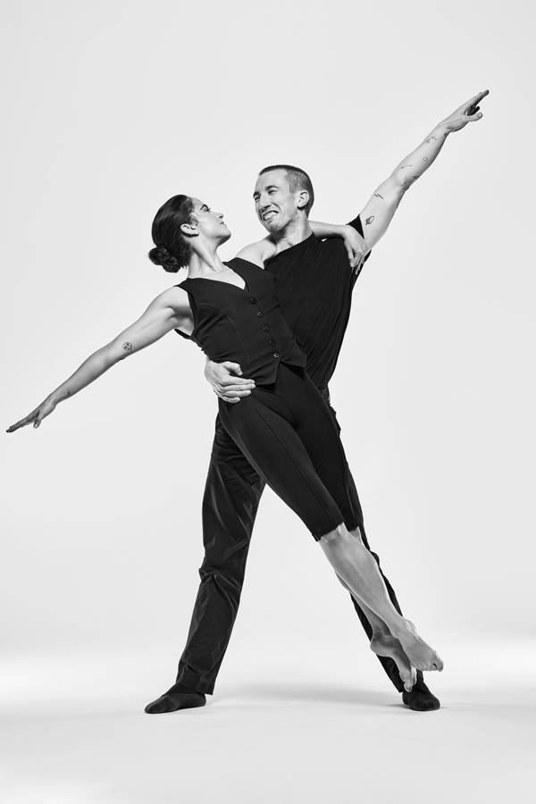Greyscael image of two dancers in black outfits.