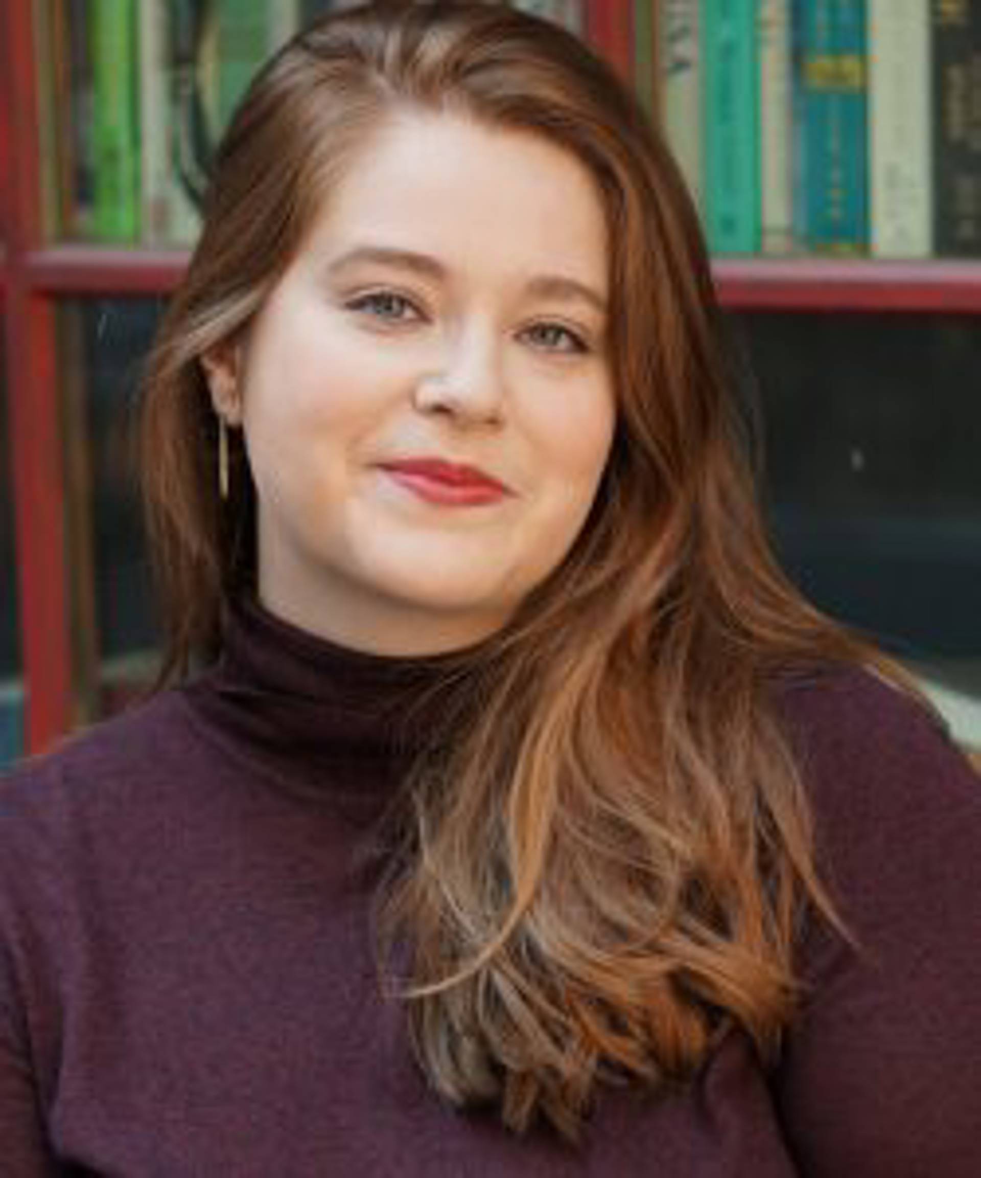 Headshot of a caucasian woman with long brown hair. 