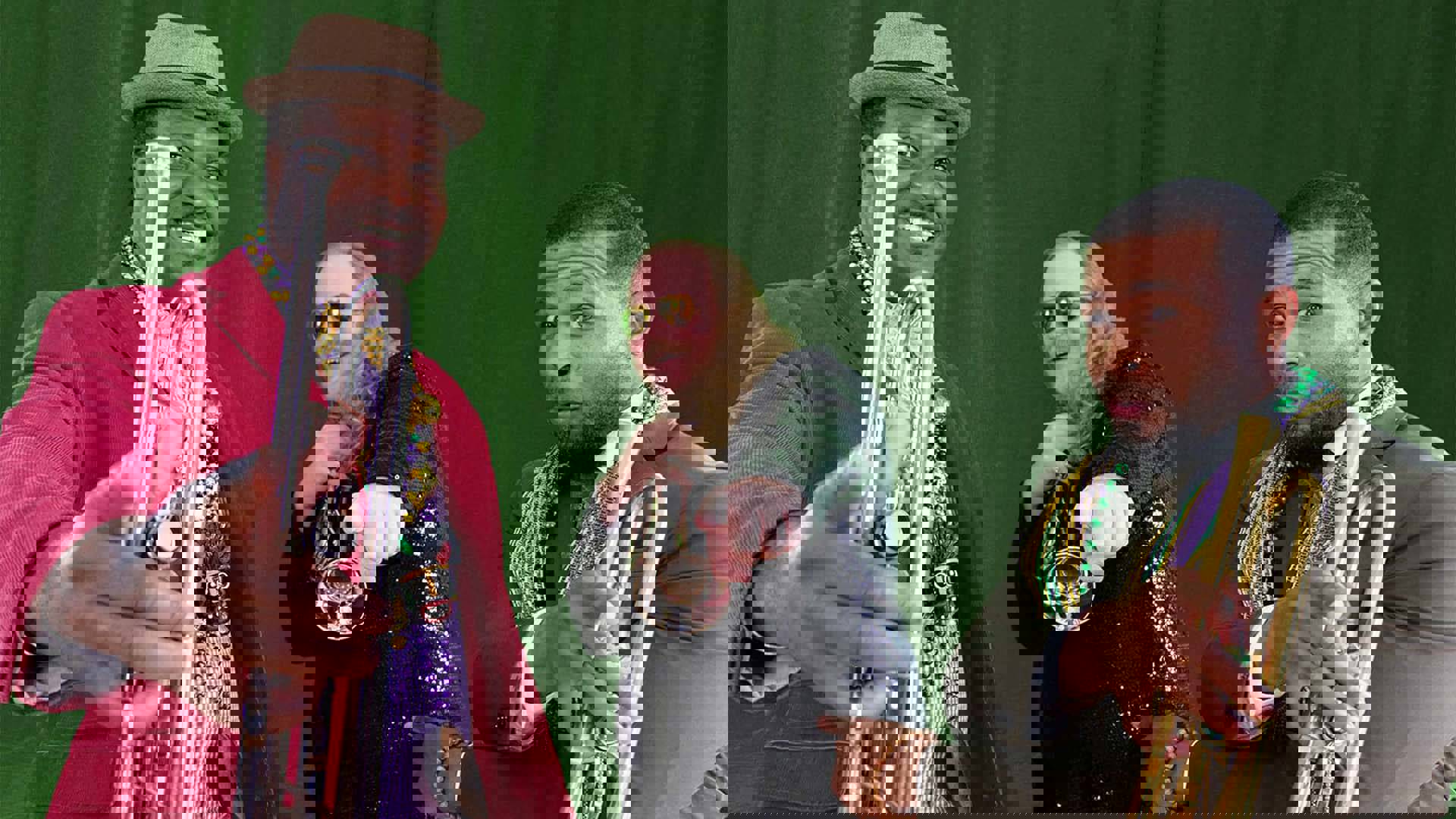 Three men holding trumpets and wearing Mardi Gras colorful beads around their necks. Two men in front are black and all are pointing to the camera, smiling.