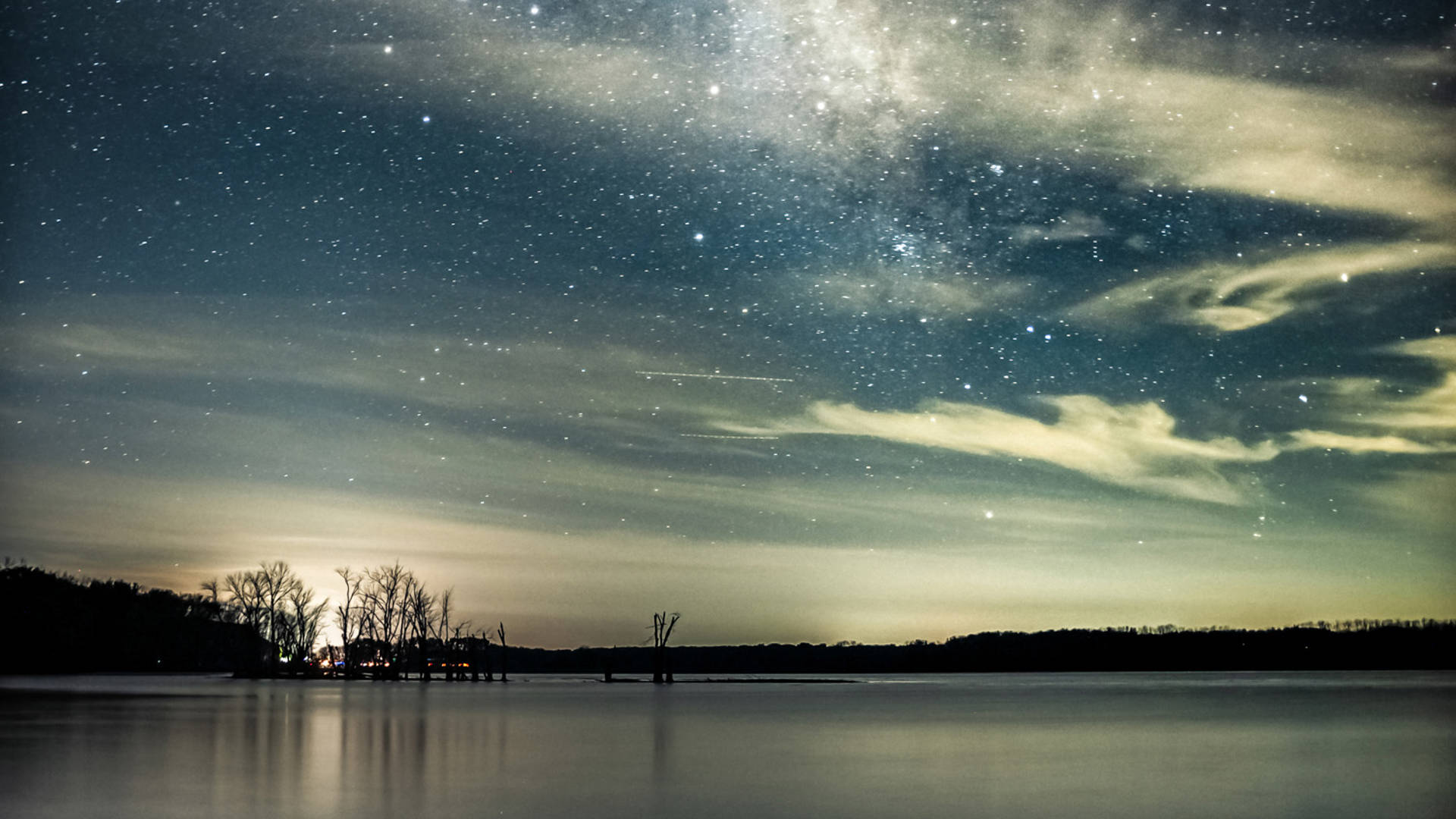 Photo of a starry night over a lake.