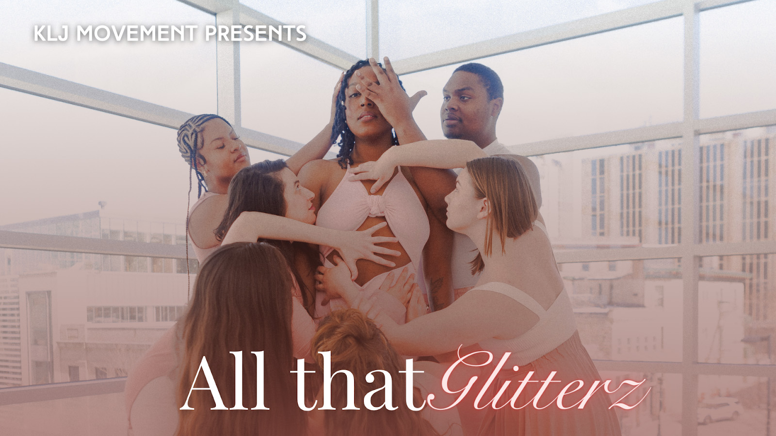 Banner Text Reads: KLJ Movement Presents All that Glitterz. An african american woman  with dark hair and dark eyes in a light pink dress stands upright as 6 other dancers surround her and place their hands on her artistically. The background is large windows looking out on buildings.