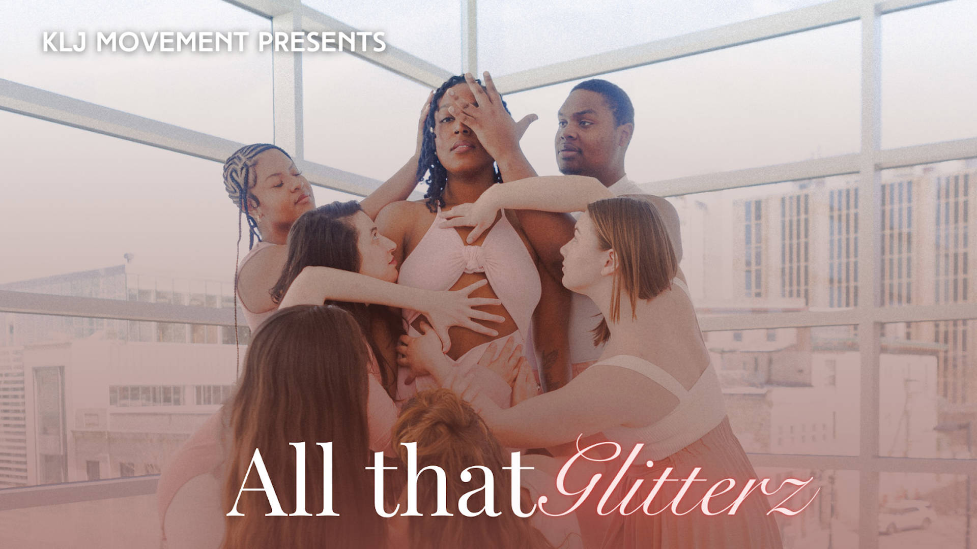 Banner Text Reads: KLJ Movement Presents All that Glitterz. An african american woman with dark hair and dark eyes in a light pink dress stands upright as 6 other dancers surround her and place their hands on her artistically. The background is large windows looking out on buildings.