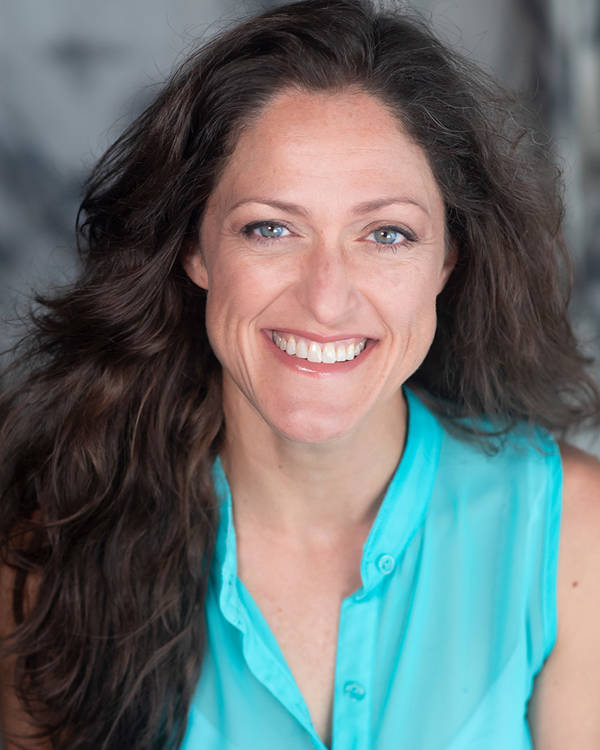 Headshot of a caucasian woman with light blue eyes and long brown hair.