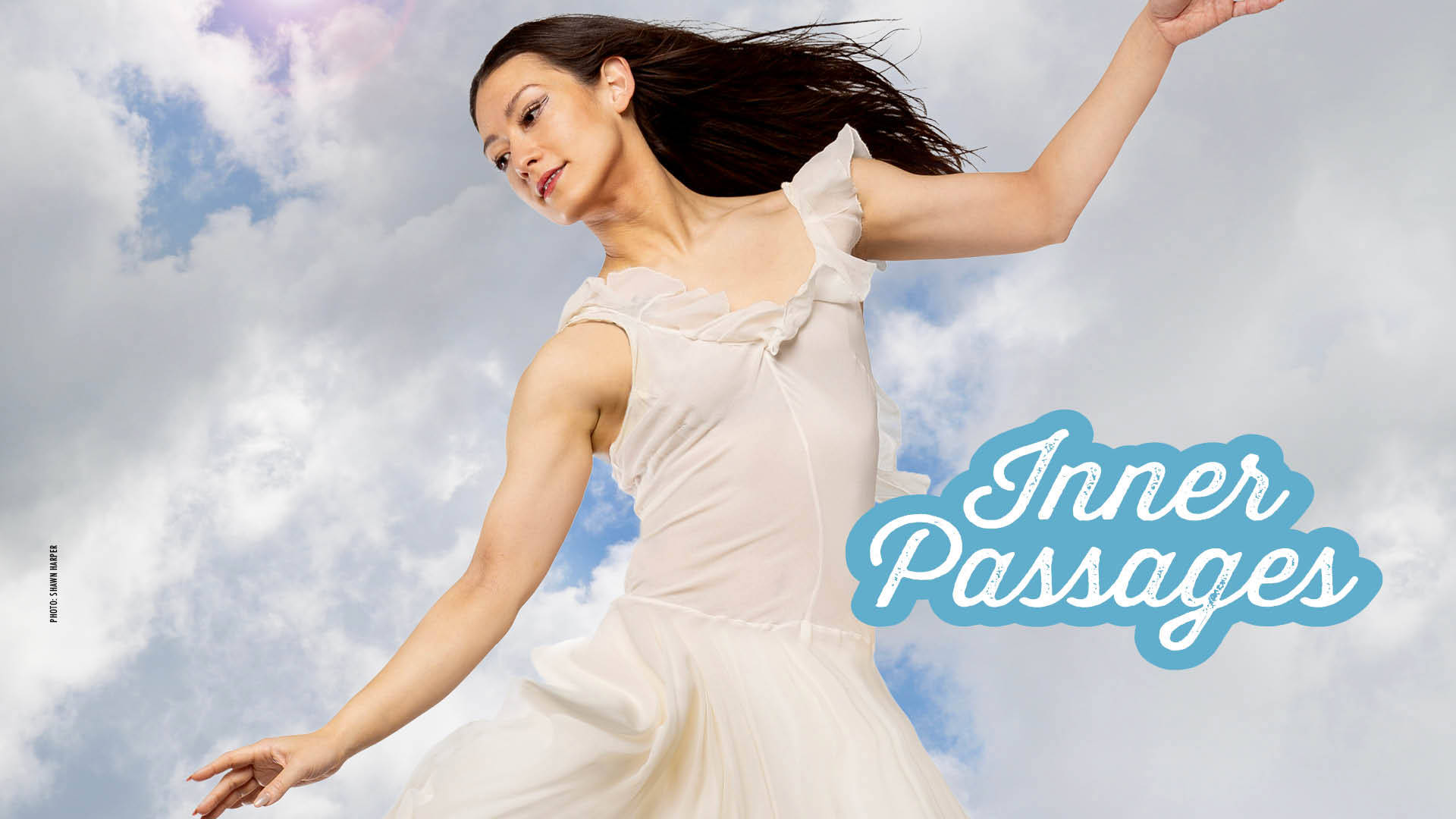 Banner reads: "Inner Passages." A light complexion dancer gracefully poses in front of a cloudy blue sky with one arm up and the other pointed down in a white flowy dress and long dark hair.