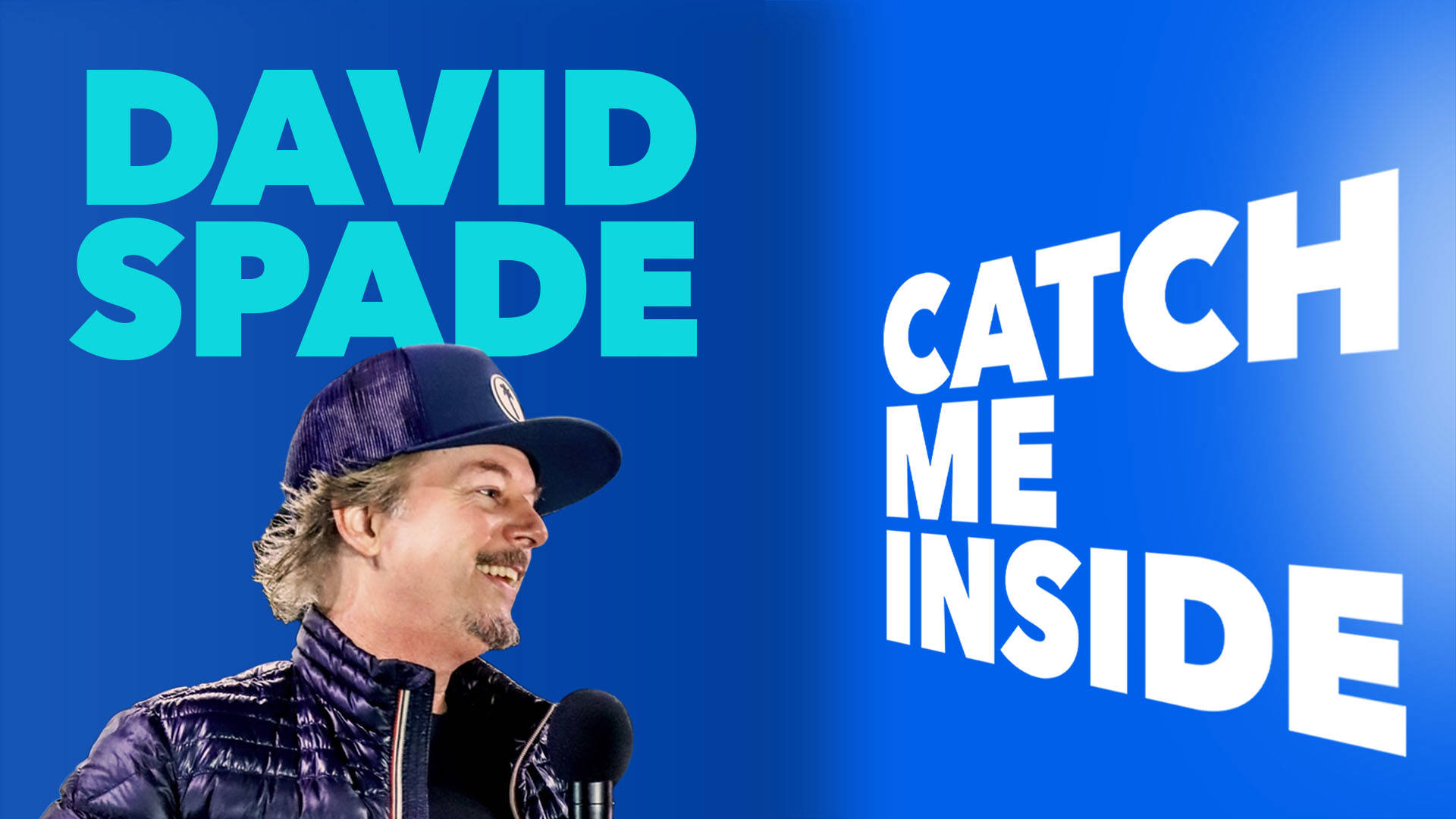 David Spade against a blue background. He is a middleaged white man with a baseball cap, blond hair and a goatee.