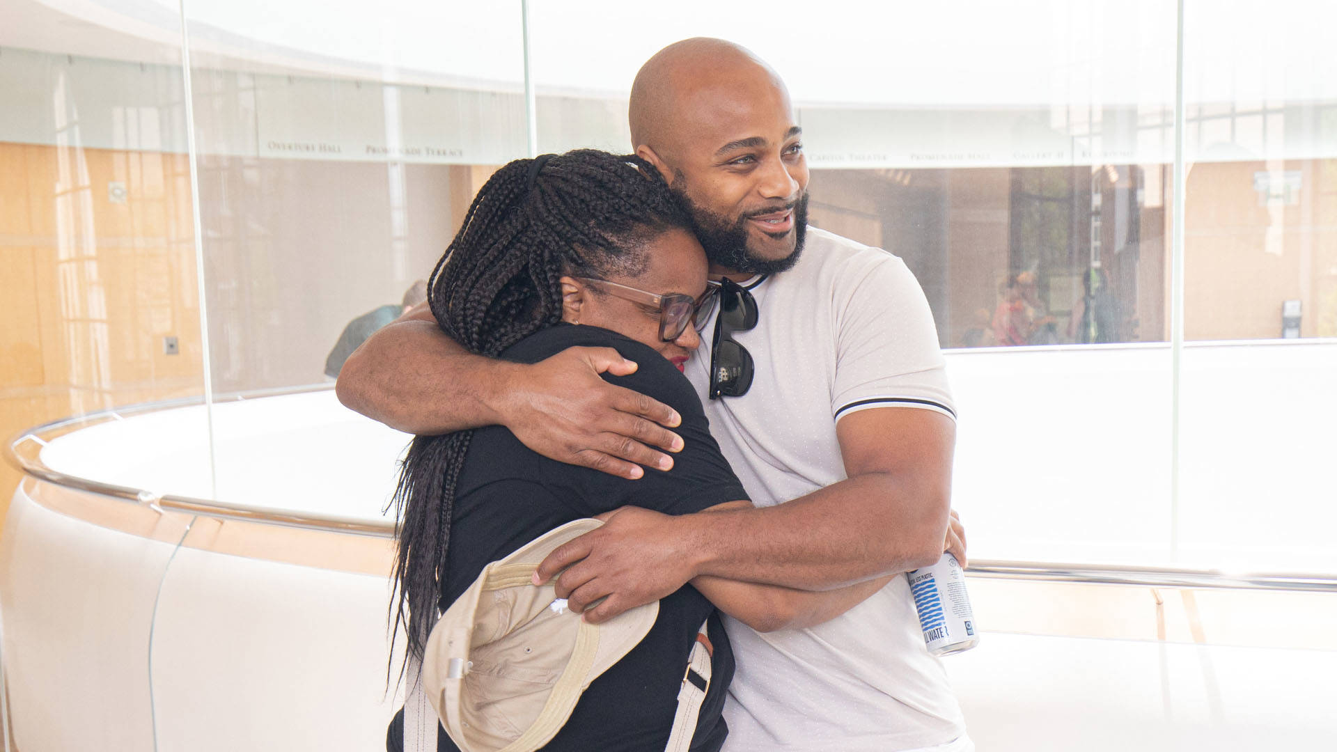 A man and a woman embrace and smile.