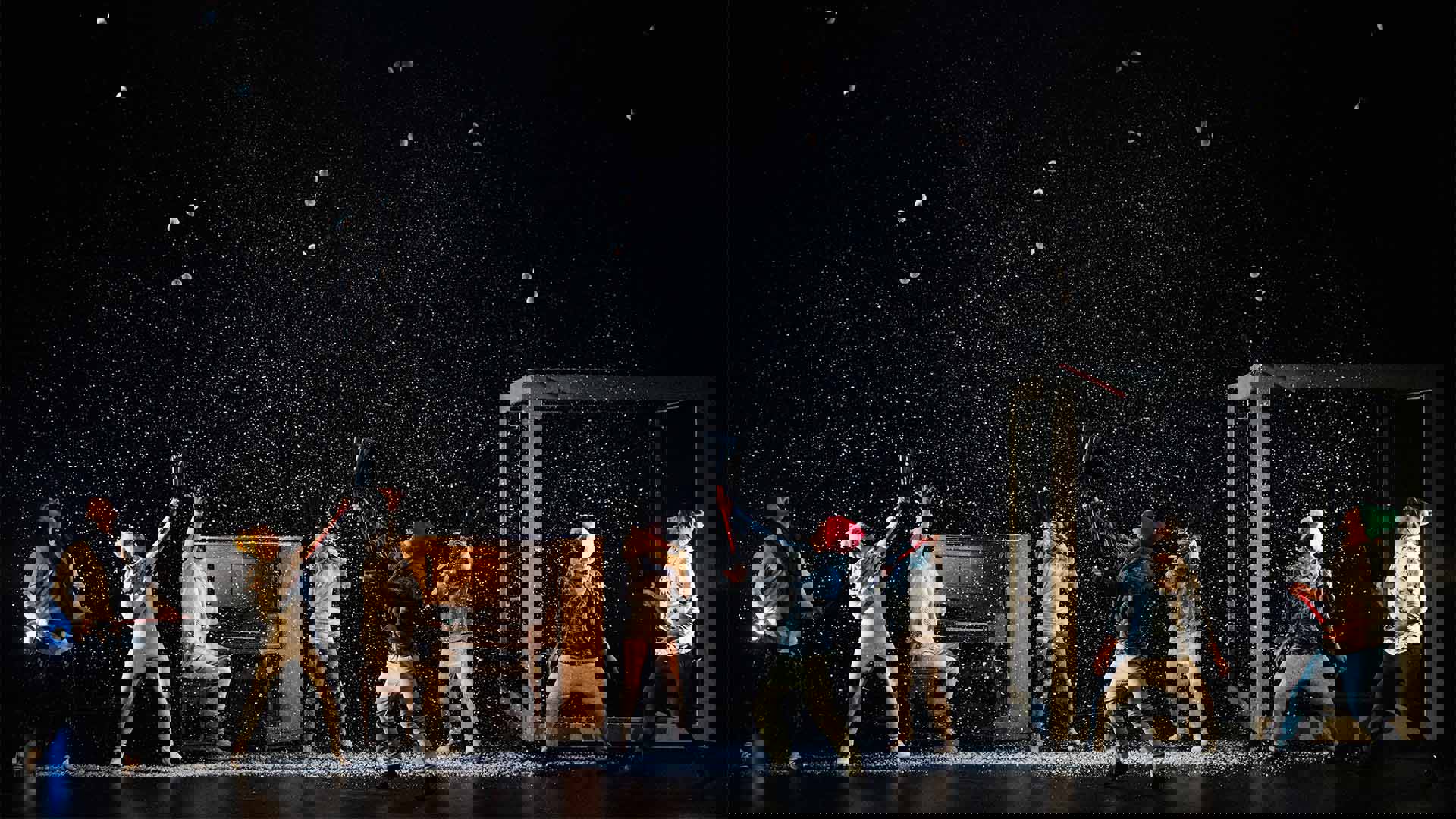 FLIP Fabrique performing on stage. Snow is coming down from above.