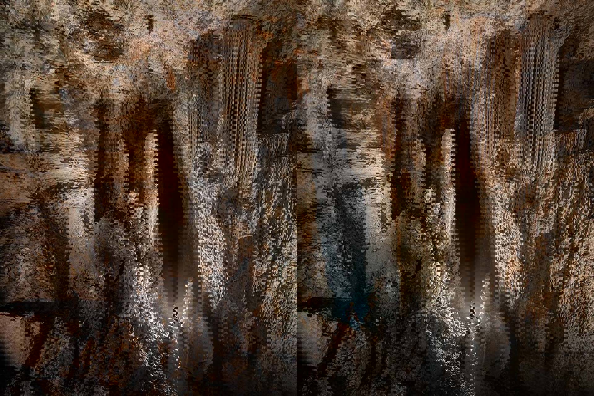 A climber in a vast cave