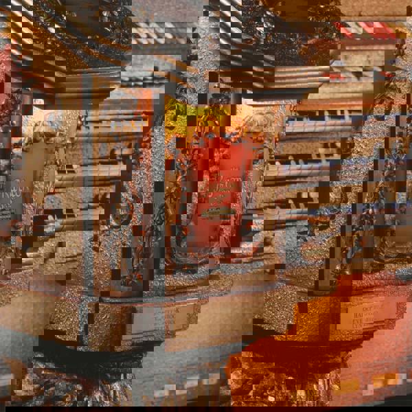 Close up of a golden and red organ console with "Barton" written on it.