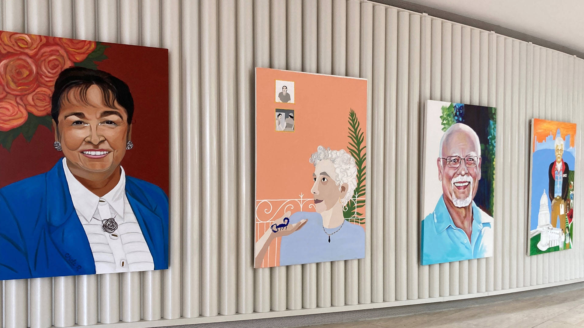Gallery wall with four large paintings. Each painting features a different person.